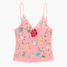 Pink floral embroidered top on a white background