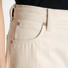 Close-up of beige pants with a white background