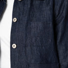 Close-up of a dark denim shirt with button 