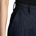 Close-up of dark blue pants with a white background