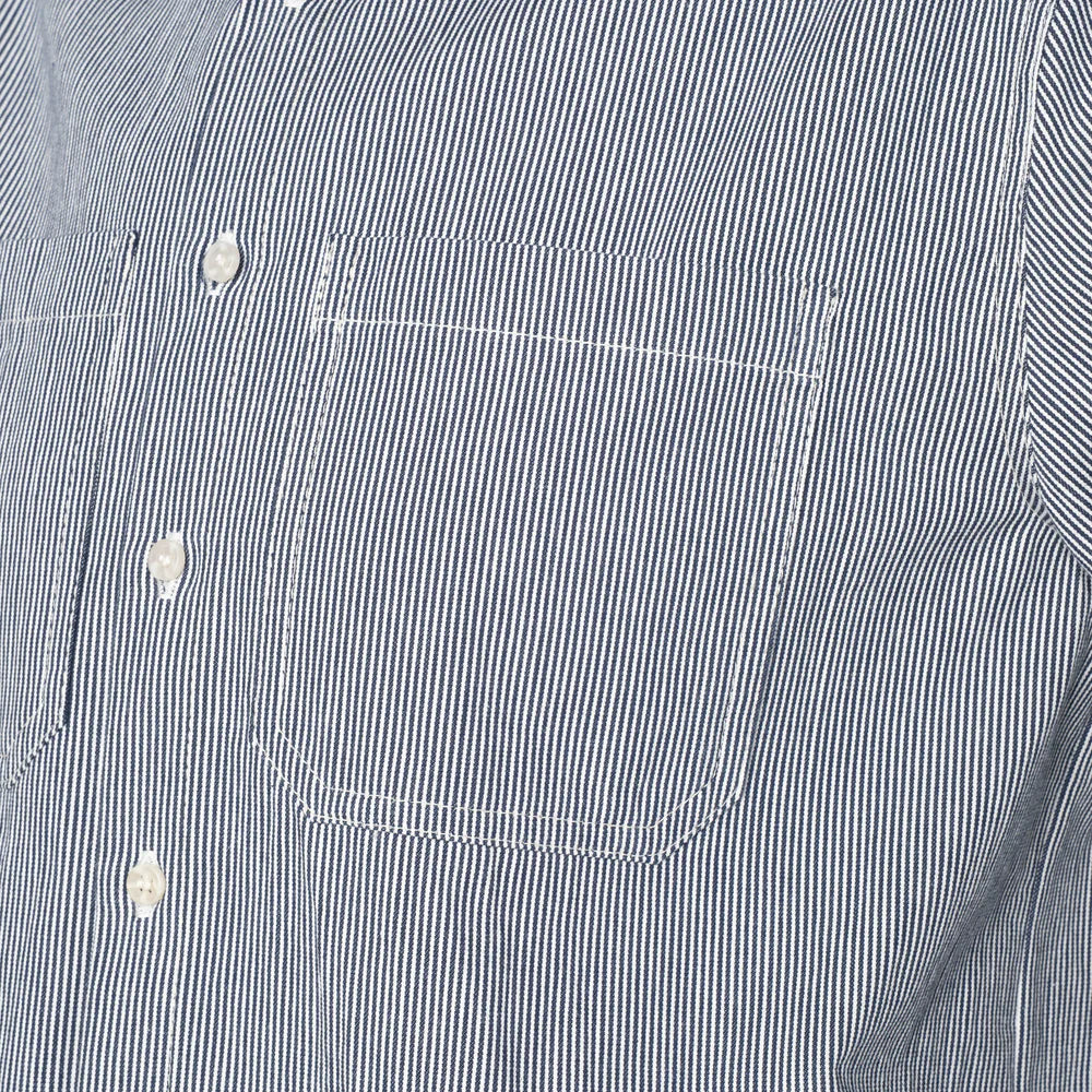 close-up of a blue and white striped shirt with pockets and buttons