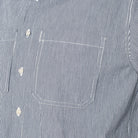 close-up of a blue and white striped shirt with pockets and buttons