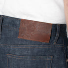 close-up of a branded leather patch on a pair of blue jeans