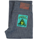 Folded blue denim jeans with a green frog label on a white background
