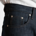 Close-up of dark blue jeans with a white background
