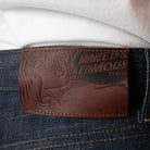 Naked & Famous Denim label on a denim fabric background