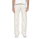 Person wearing white pants on a plain background