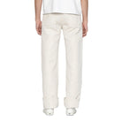 Person wearing white pants on a plain background