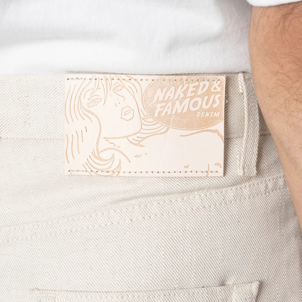 Naked & Famous Denim label on a light-colored denim fabric