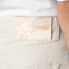 Naked & Famous Denim label on a light-colored denim fabric