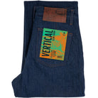 Folded blue denim jeans with a brand label on a white background
