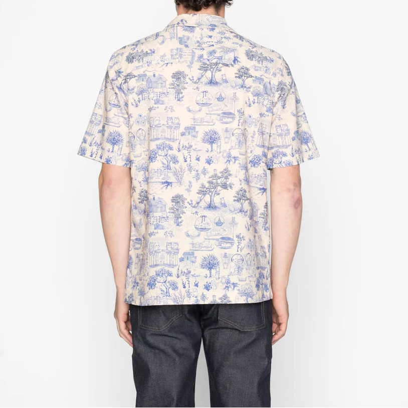 Person wearing a patterned shirt on a white background