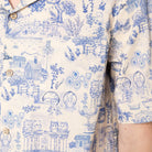 Close-up of a blue and white patterned shirt with cat-themed design.