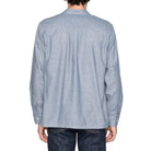 Person wearing a light blue striped shirt on a white background