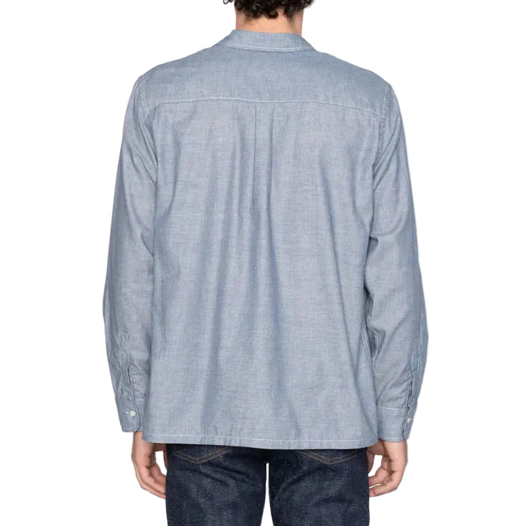 Person wearing a light blue striped shirt on a white background