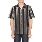Man wearing a black and beige striped shirt on a white background