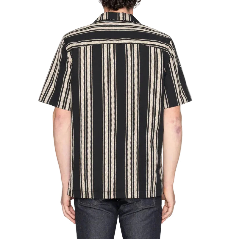 Person wearing a black and beige striped shirt on a white background