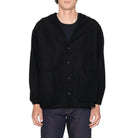 Person wearing a black jacket on a white background