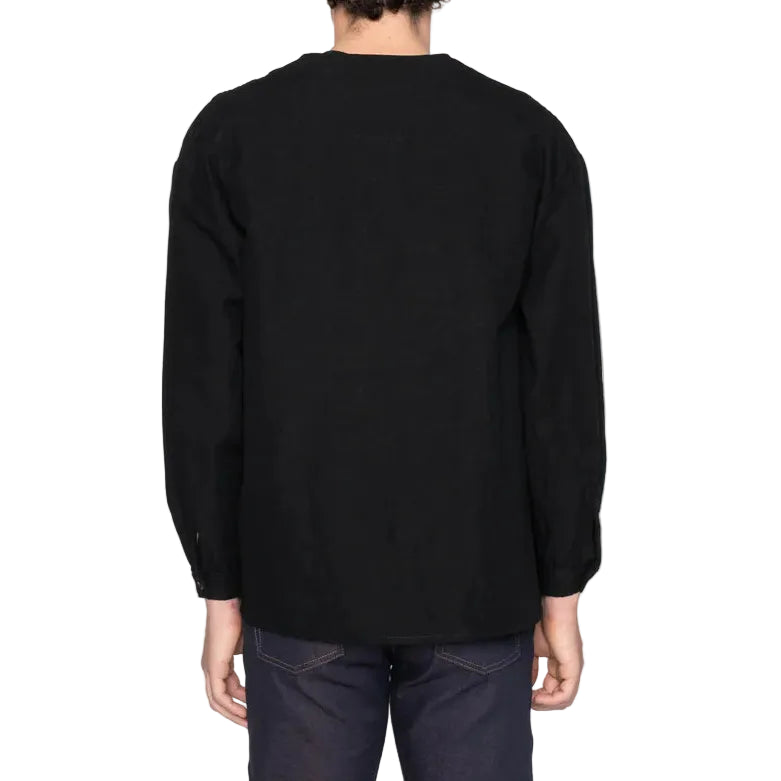 Person wearing a black long-sleeve shirt on a white background