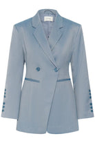 Light blue blazer with button details on a white background
