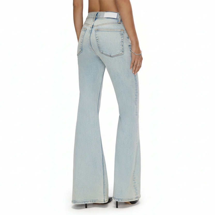 Light blue flared jeans worn by a person on a white background