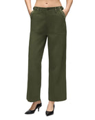 Model in army green military style pants on a white background