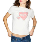 Woman wearing a white t-shirt with a pink heart design on a plain background
