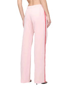 Pink pants with a red stripe on a white background