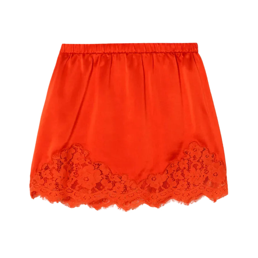 Red satin skirt with lace trim on a light white background