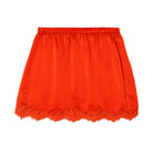 Red satin skirt with lace trim on a light white background