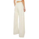 Woman wearing wide-leg pants on a white background