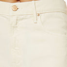 Close-up of beige pants with a brand logo on the button.