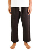 Person wearing brown pants on a white background