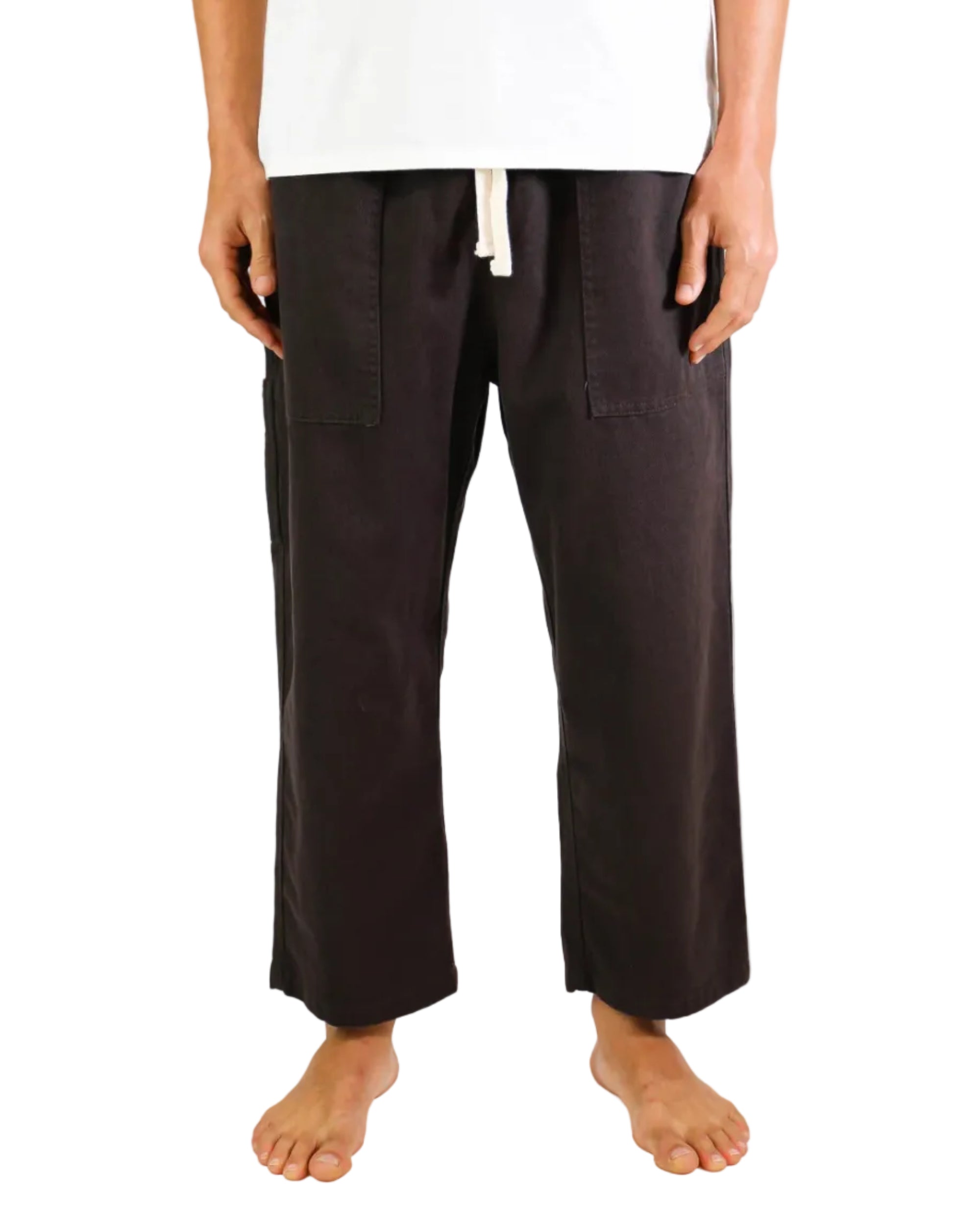 Person wearing brown pants on a white background