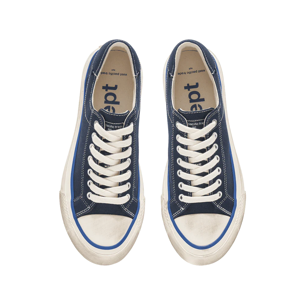 Pair of blue sneakers with white laces on a white background