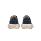 Pair of navy blue sneakers with white soles on a white background