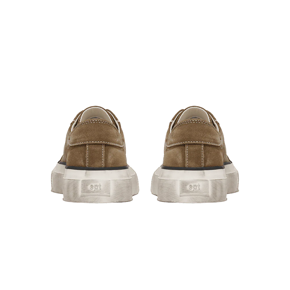 Pair of brown sneakers with white soles on a white background