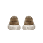 Pair of brown sneakers with white soles on a white background
