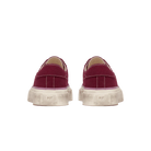 Pair of red sneakers with white soles on a white background