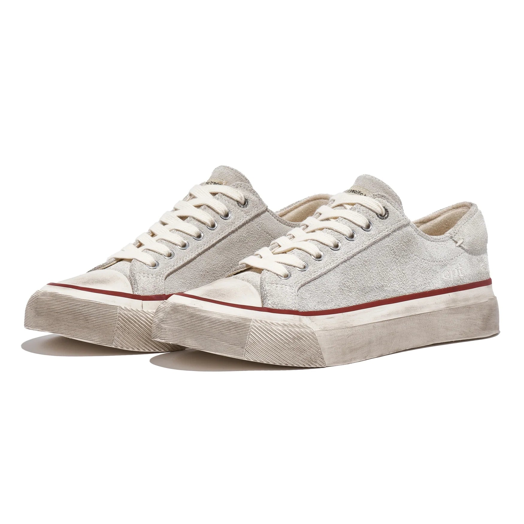 Pair of white sneakers with red accents on a white background