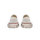Pair of white sneakers with red accents on a transparent background
