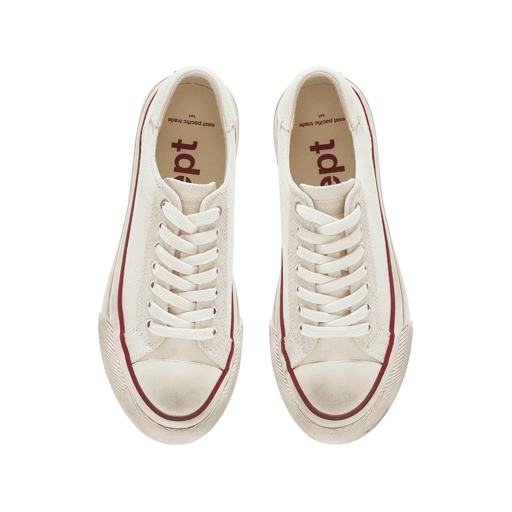 Beige sneakers with red soles on a white background