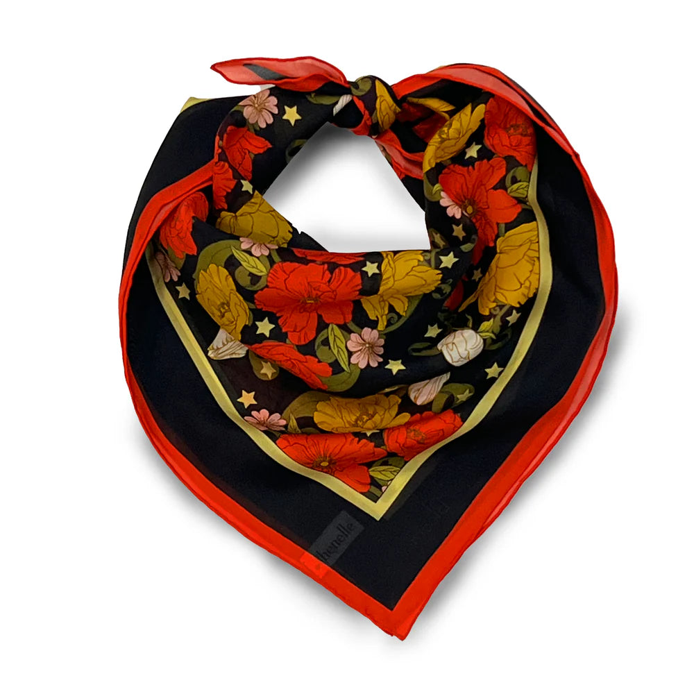 Colorful floral patterned scarf with red border on a white background