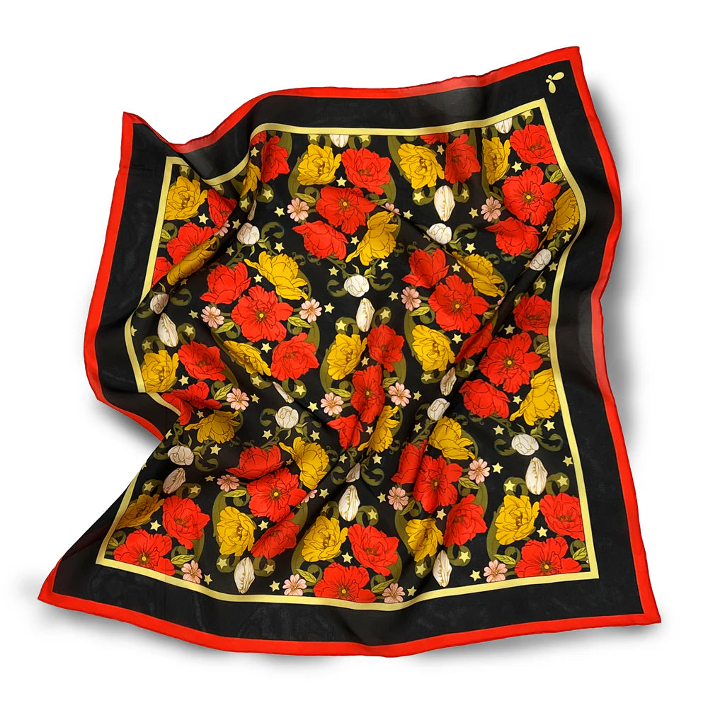Floral patterned scarf with red, yellow, and black colors on a white background