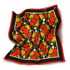 Floral patterned scarf with red, yellow, and black colors on a white background