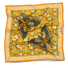 Butterfly patterned scarf with orange border on a white background