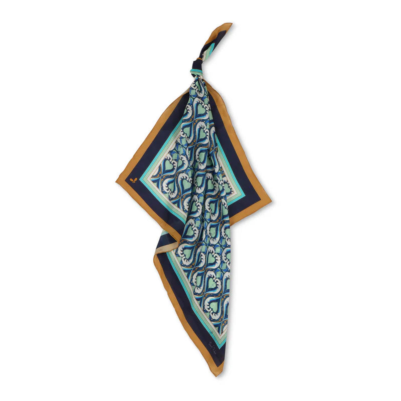 Patterned scarf with blue and green design on a white background