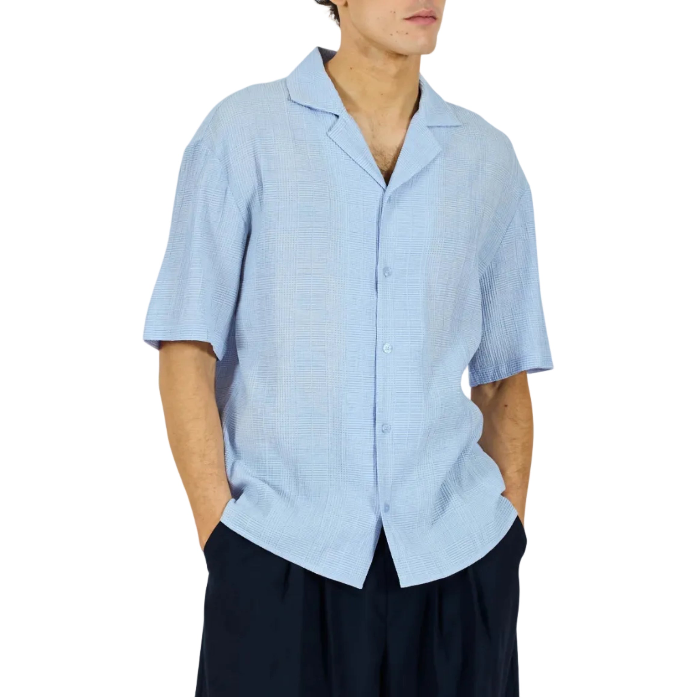 Person wearing a light blue shirt and dark shorts on a white background