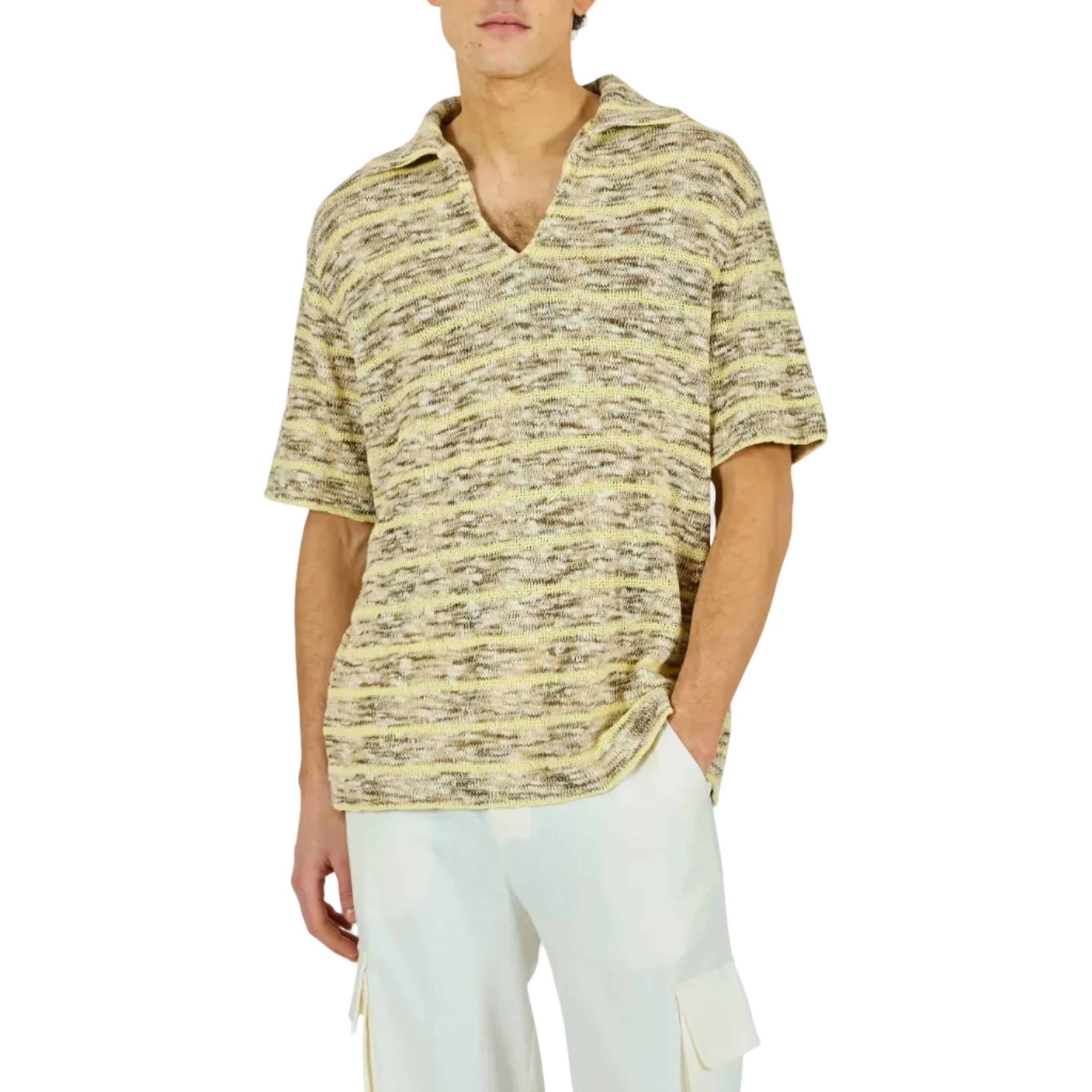 Man wearing a patterned shirt and white pants on a white background