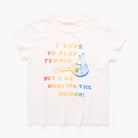 A white short-sleeve t-shirt with a colorful graphic print on the front. The graphic features the text 'I LOVE TO PLAY TENNIS BUT I AM HERE FOR THE DRINKS!' in a rainbow gradient, alongside an illustration of a tennis racket and two beer bottles.